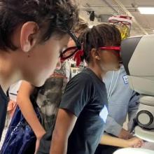 thinkSTEM students looking in microscope