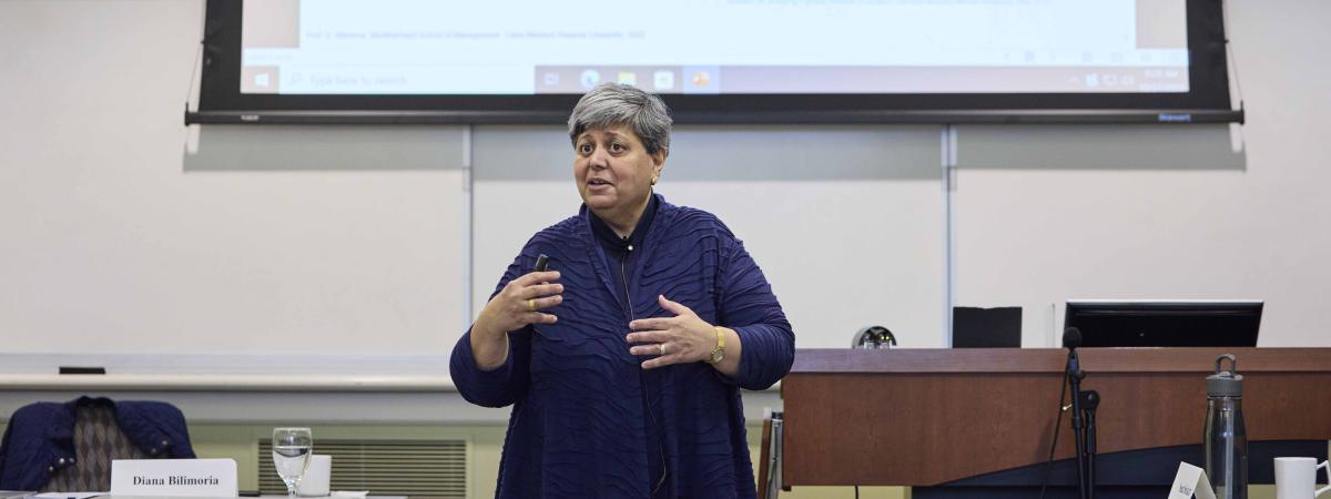 Diana Bilimoria gestures with her hands, presenting to a class