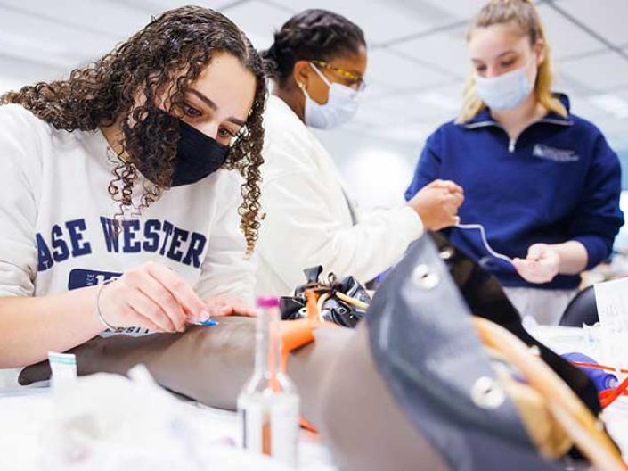 Students with masks working together in a lab