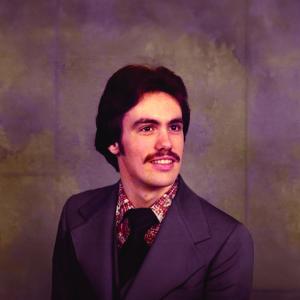 Jeffrey Mills smiles at camera while wearing formal attire