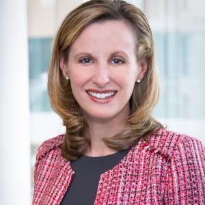 Amanda Pinney smiles at camera while wearing formal attire