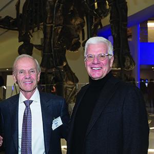 Don Shina and Kevin Waidmann smile at camera while wearing formal attire