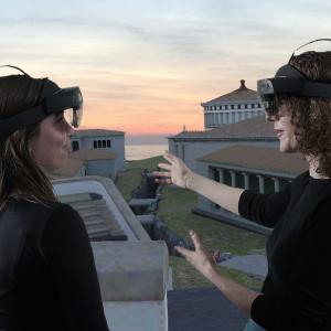 People with virtual reality headsets looking at an ancient city