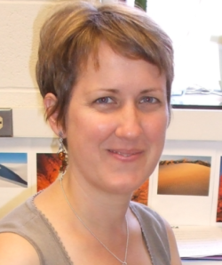 Anita Zaremba headshot turned slightly to the side with taupe tank top