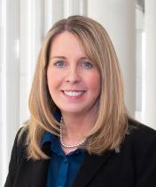 Michele Bourrie-Schafer, wearing formal attire, smiles at camera