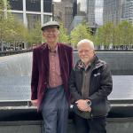 Warren Gibson, left, wears a dark hat and burgundy jacket while Bill Baker wears a dark jacket. Both are standing in front of the 9/11 Memorial.