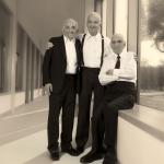 Jack, Joseph and Morton Mandel smile for camera wearing formal attire