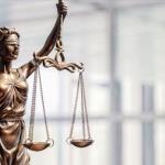Depiction of justice statue, blindfolded, holding scales