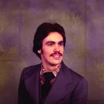 Jeffrey Mills smiles at camera while wearing formal attire