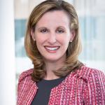 Amanda Pinney smiles at camera while wearing formal attire