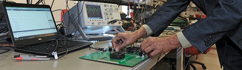 A researcher testing computer equipment in a lab
