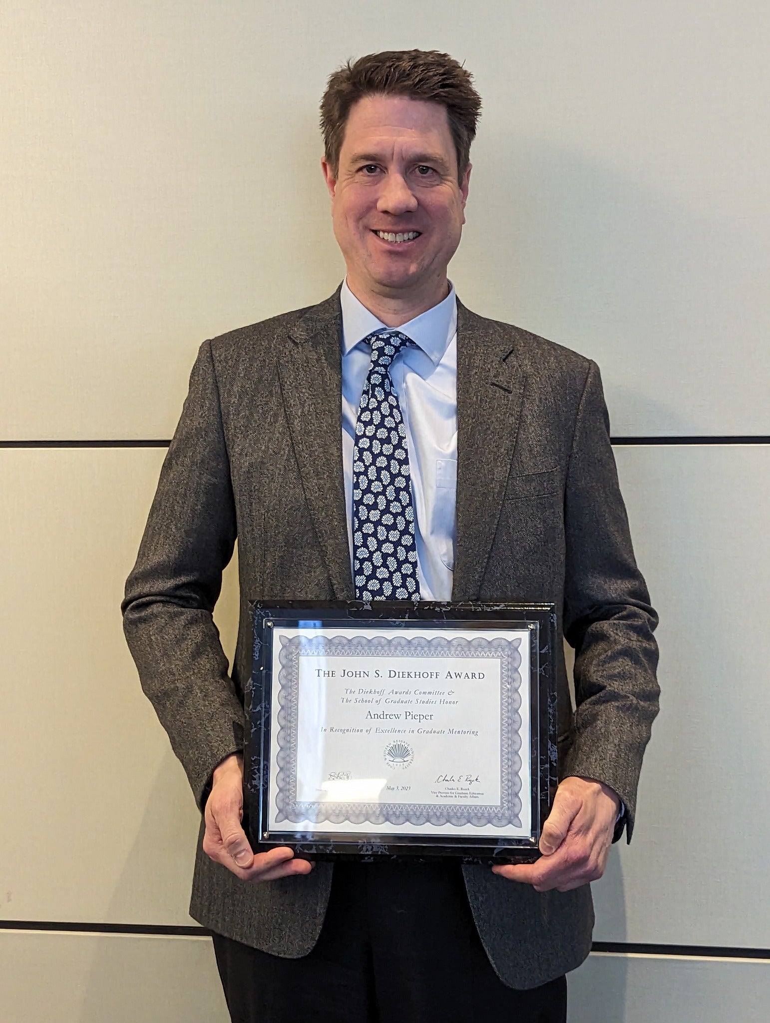 photo of professor pieper holding Diekhoff certificate