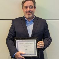 photo of professor mears holding Diekhoff certificate