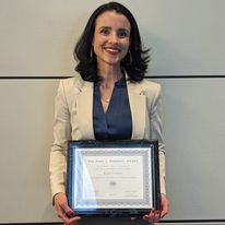 photo of professor coburn holding Diekhoff certificate