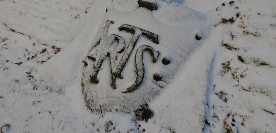 Snow covering the Arts Shield outside Yost Hall