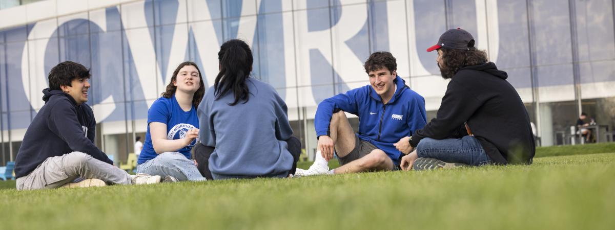 group of students sitting and talking in front of Tinkham Veale University Center