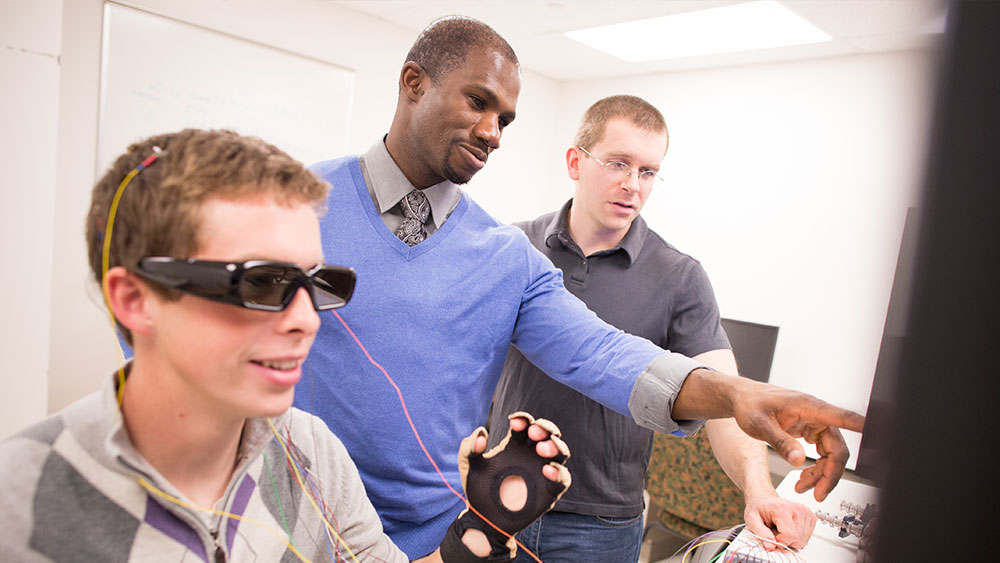 man wearing hololens interacting with a 3D heart cross-section