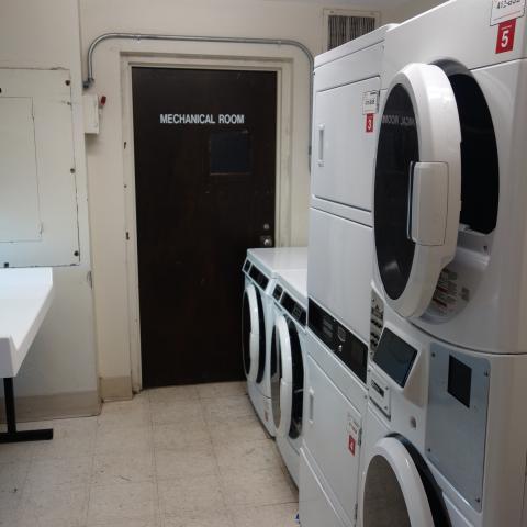 Taft House Laundry room showing stacked washing and drying machines