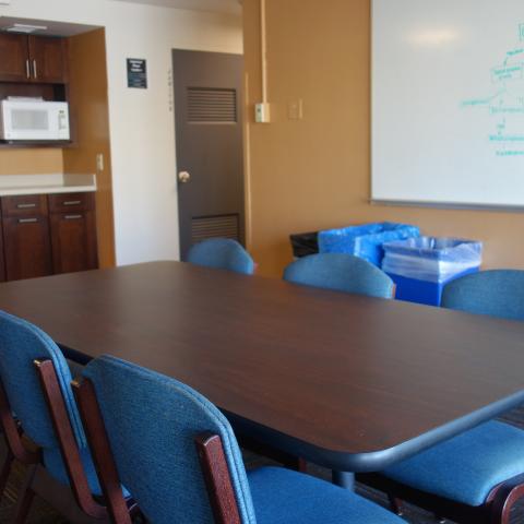 Taplin House 2nd Floor Lounge and Kitchenette showing white board, table, chairs, and microwave