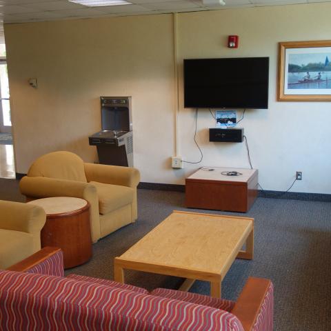 Pierce House Common Room showing furniture, television, and wall-mounted water bottle filler