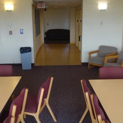 Clark Tower Upper Floor Lounge Facing Elevators with tables and chairs