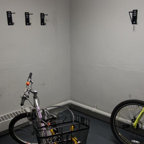 Glaser House Basement Bike Storage with wall-mounted hooks and two bikes