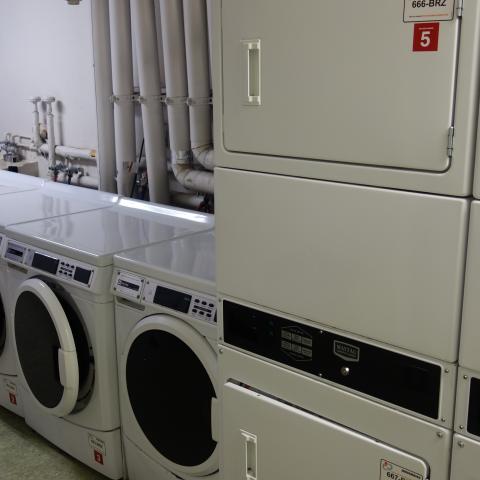 Michelson House Basement Laundry Room showing washers and stacked dryers