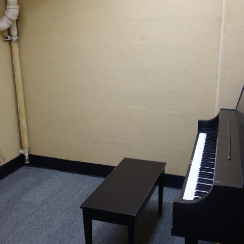 Michelson House Basement Practice Room showing common piano and bench