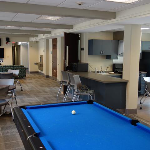 Tippit House Common Room showing pool table, kitchen, and furniture