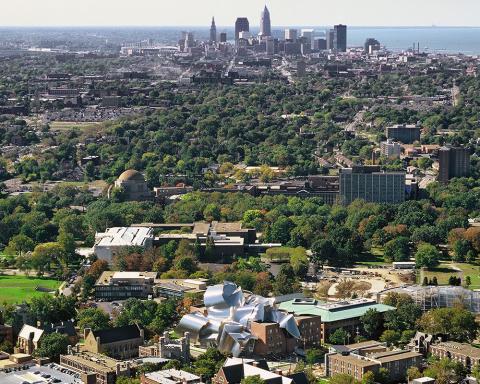 Aerial view of downtown Cleveland, with Case Western Reserve University campus in foreground and Lake Erie in background