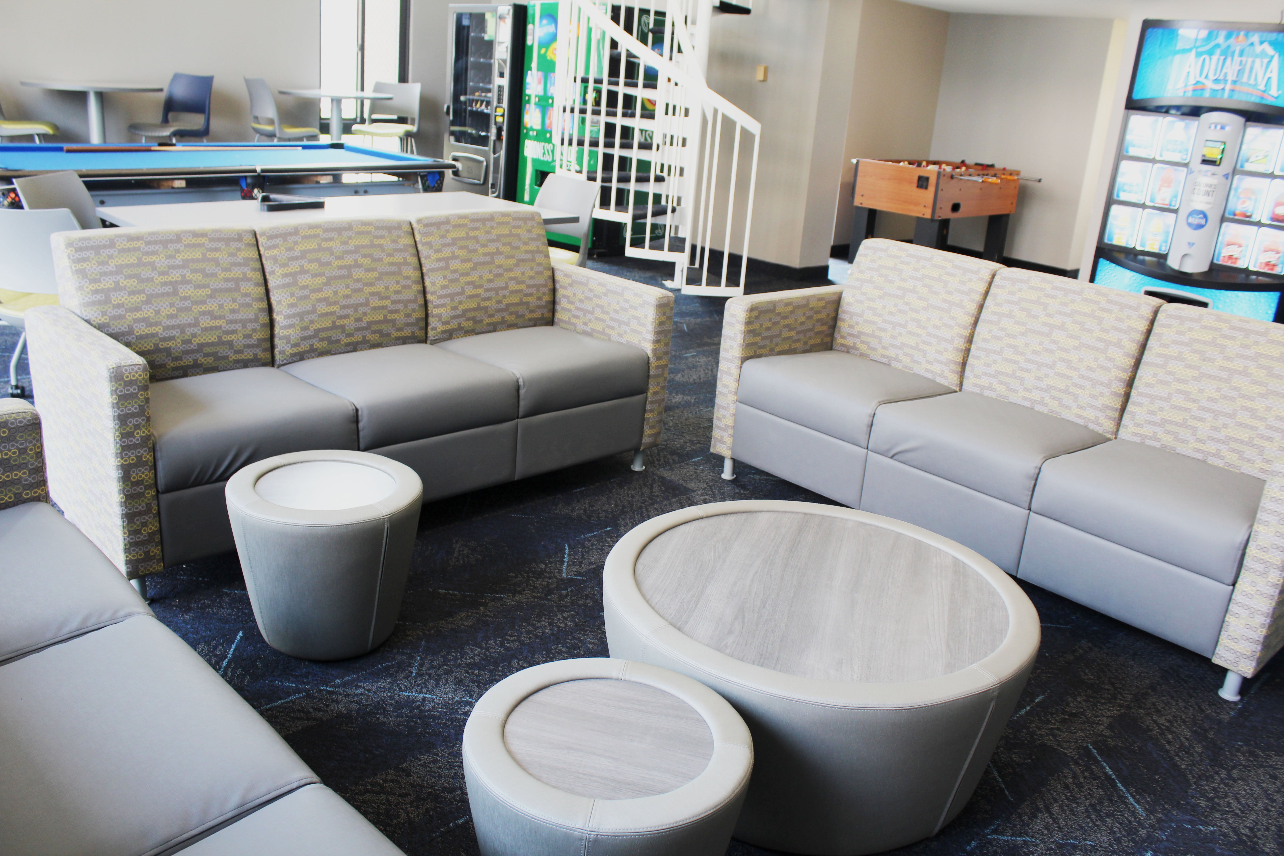 Clarke Tower Lounge with couches, coffee tables, game tables, and vending machine