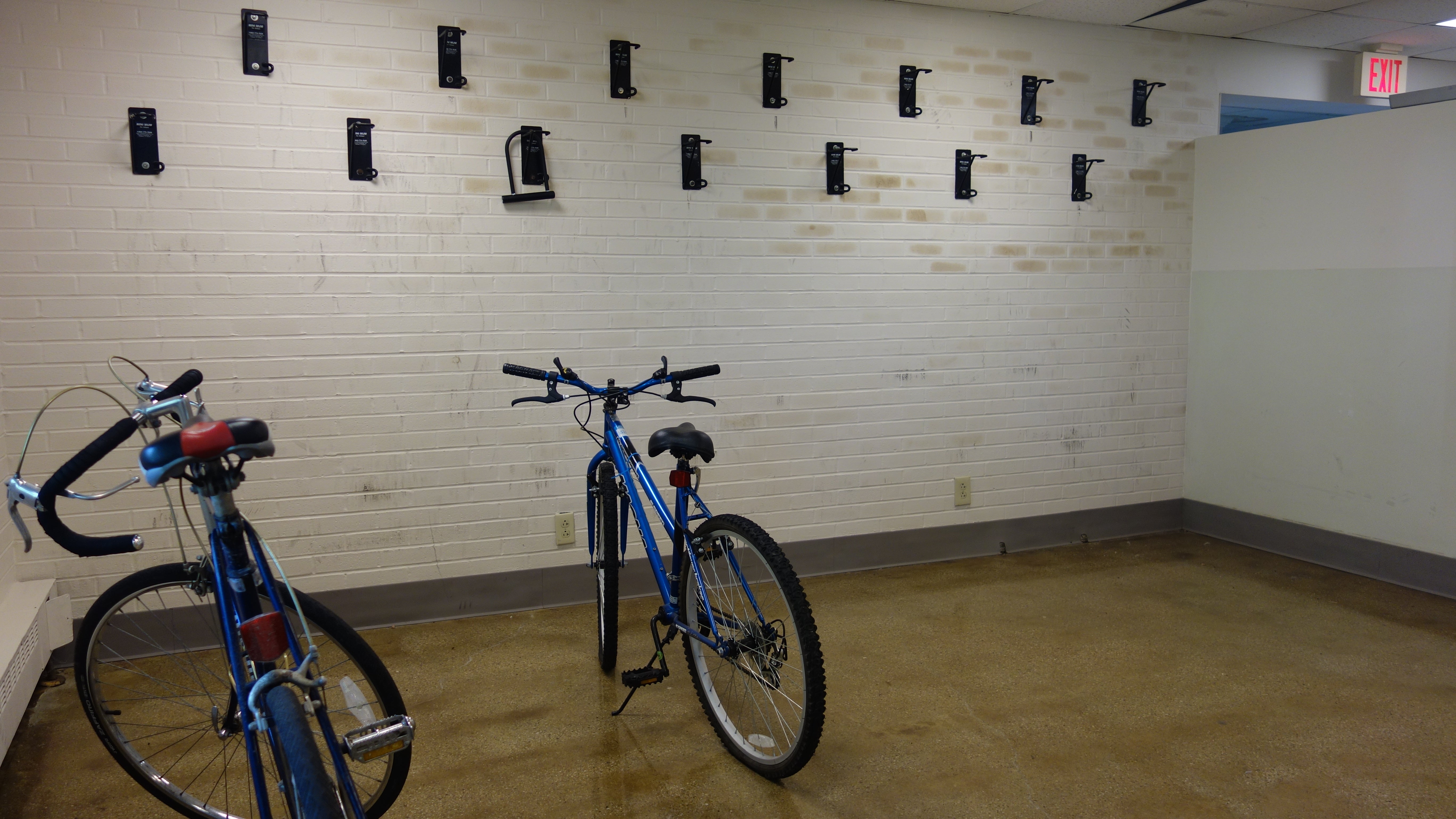 Smith House indoor bike storage room with wall-mounted bike hooks