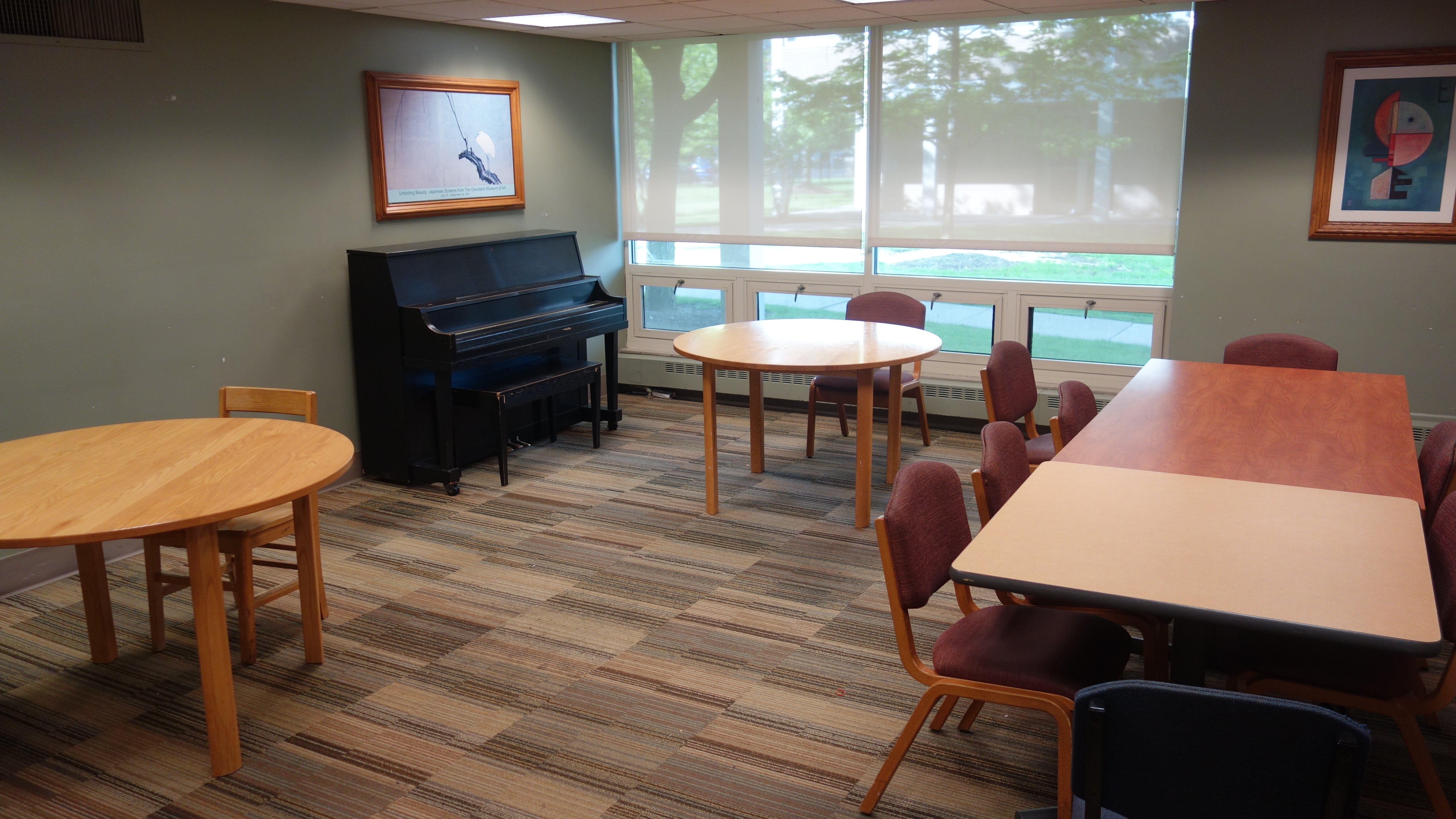 Taft House Kitchen Lounge with tables, chairs, and common piano