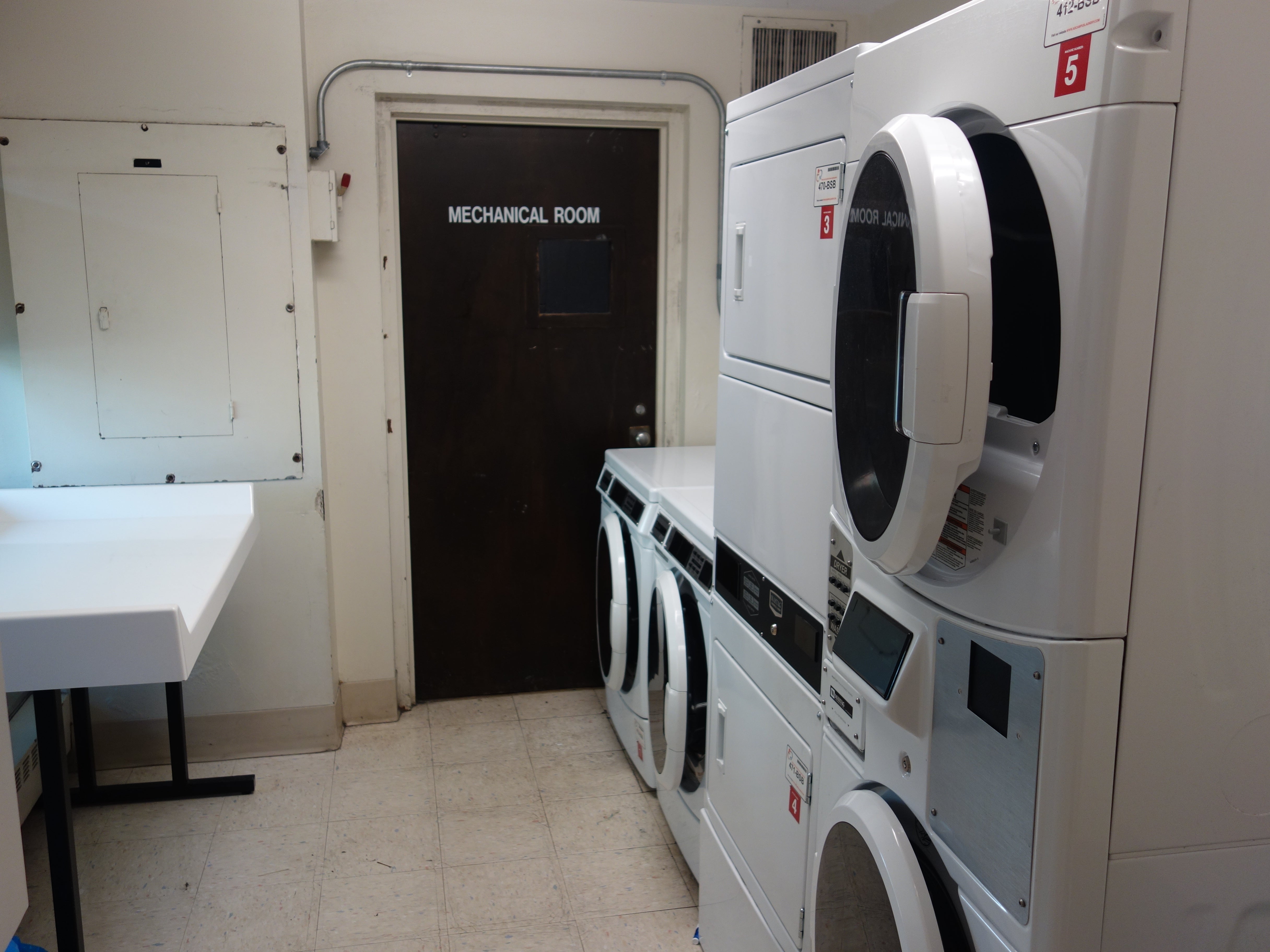 Taft House Laundry room showing stacked washing and drying machines