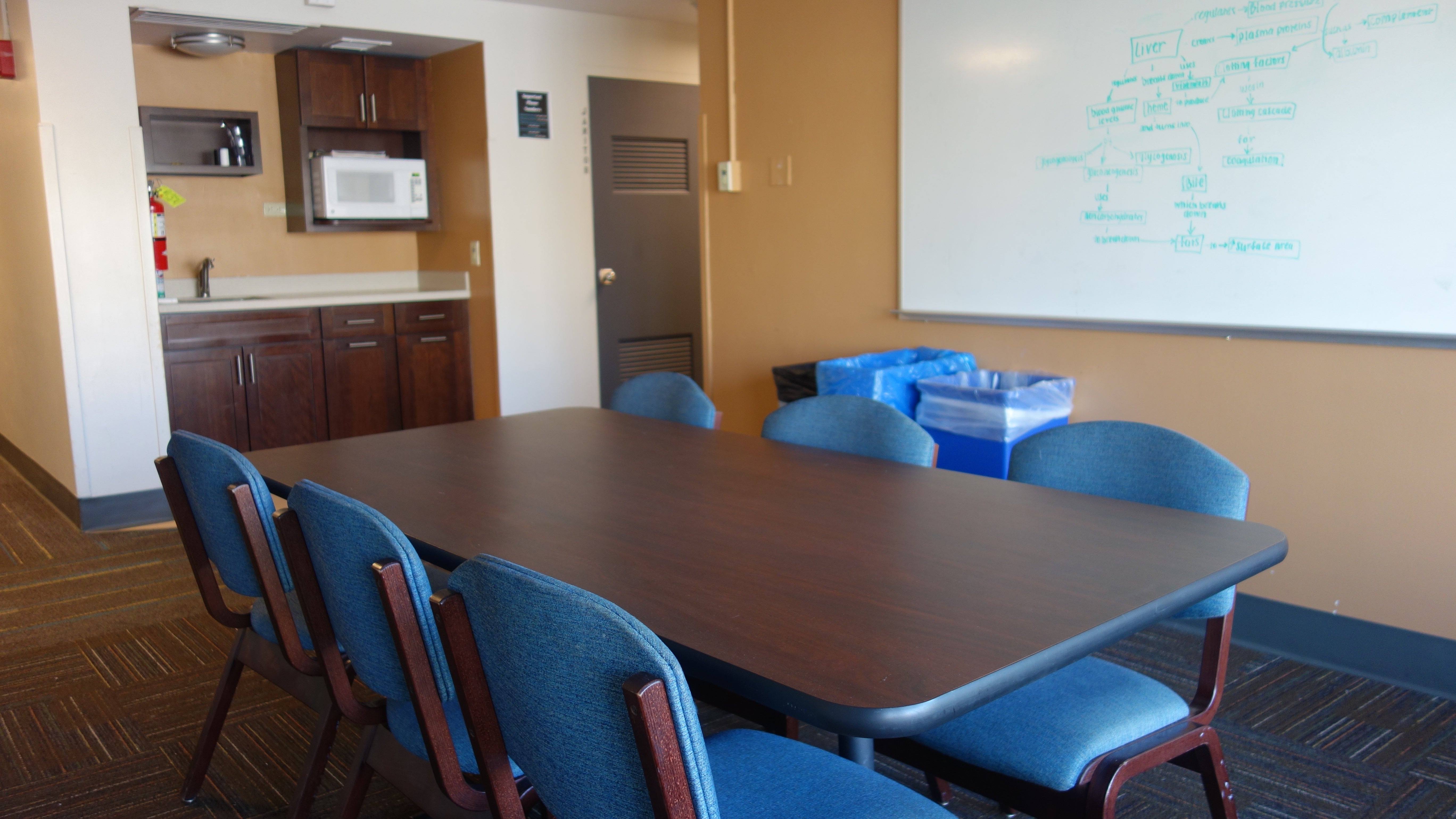 Taplin House 2nd Floor Lounge and Kitchenette showing white board, table, chairs, and microwave