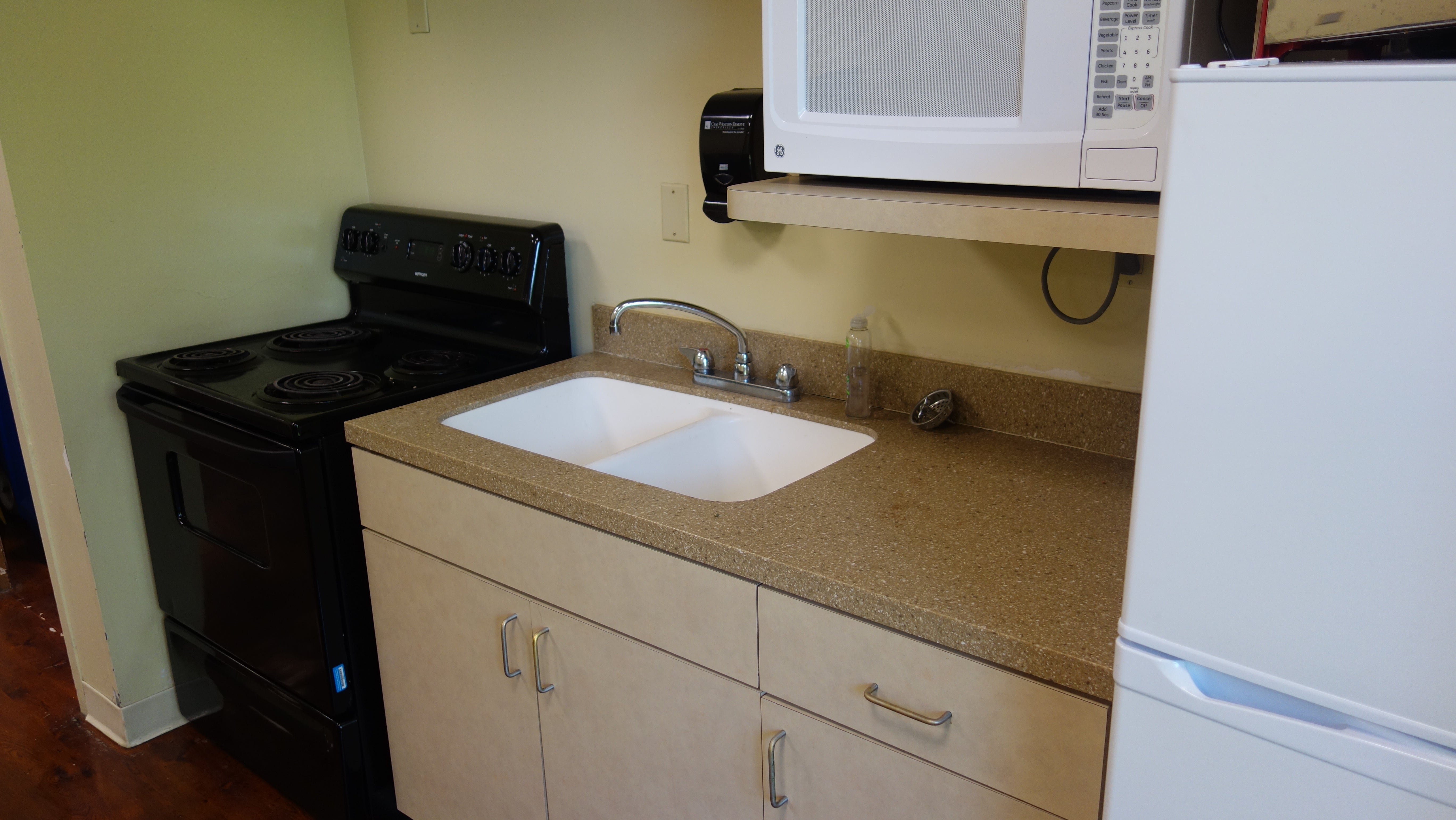Tyler House 1st Floor Kitchen with oven, sink, microwave, and fridge
