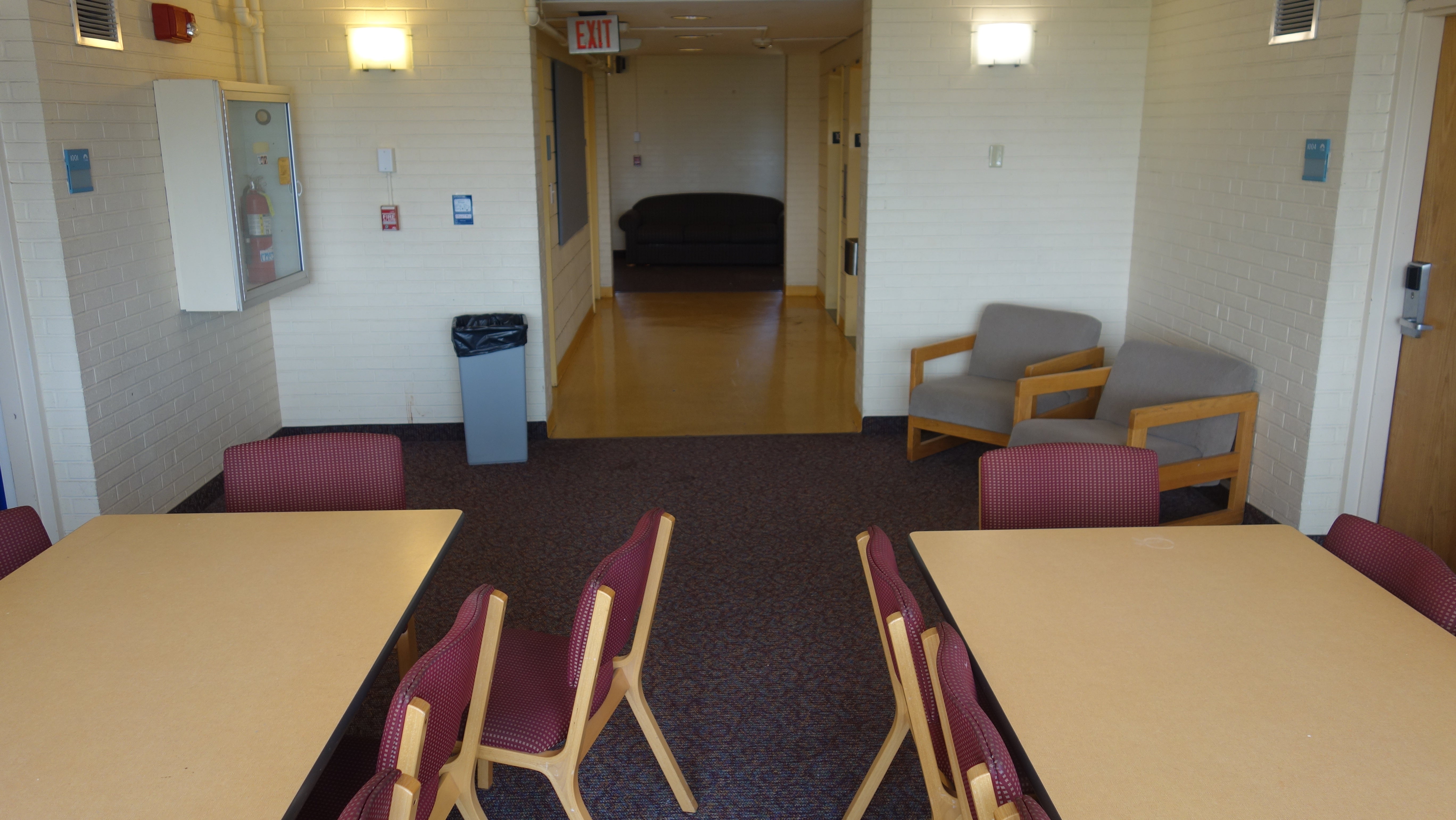 Clark Tower Upper Floor Lounge Facing Elevators with tables and chairs