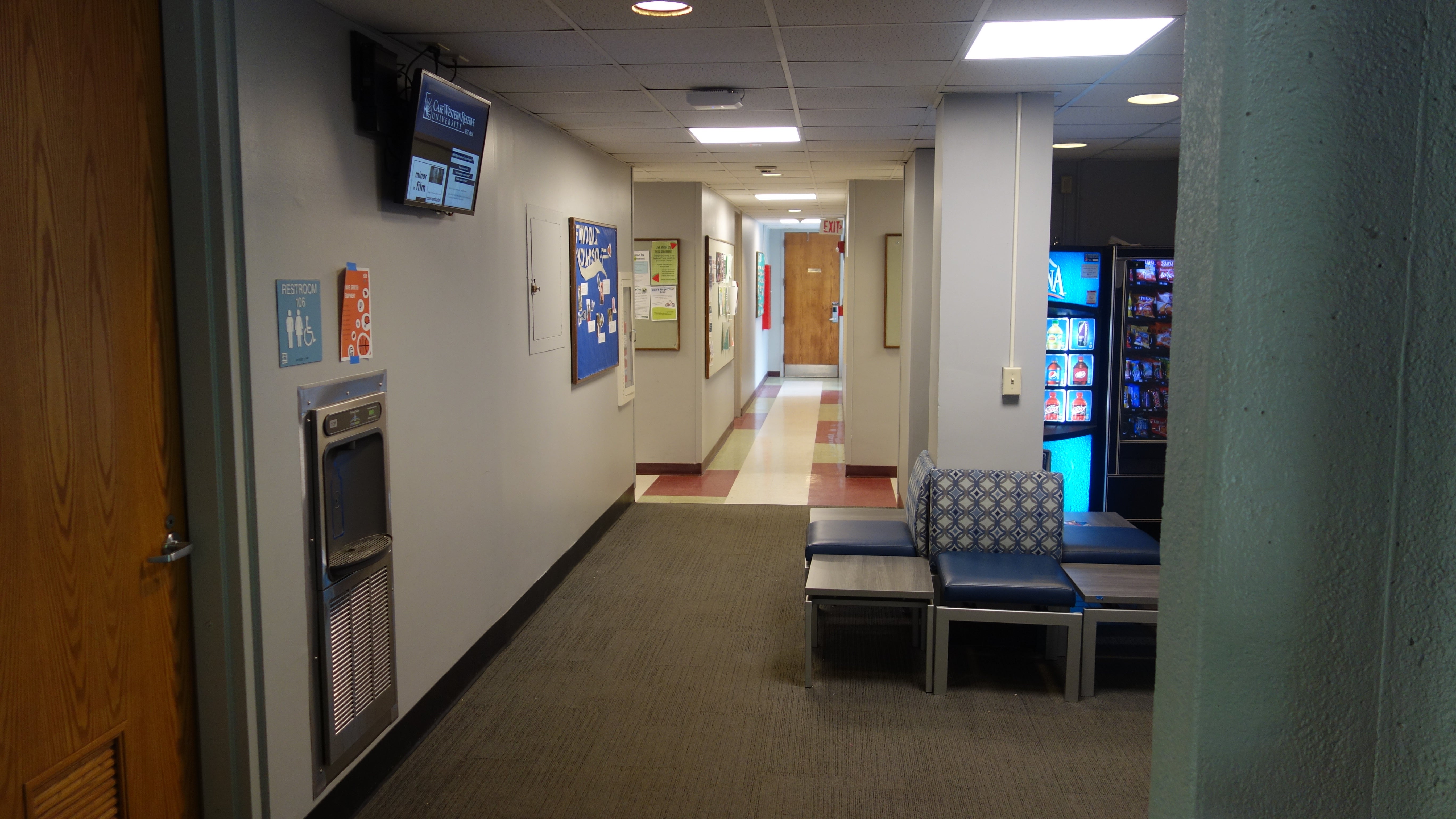 Kusch House 1st Floor Hallway showing rest room, chairs, and vending machines