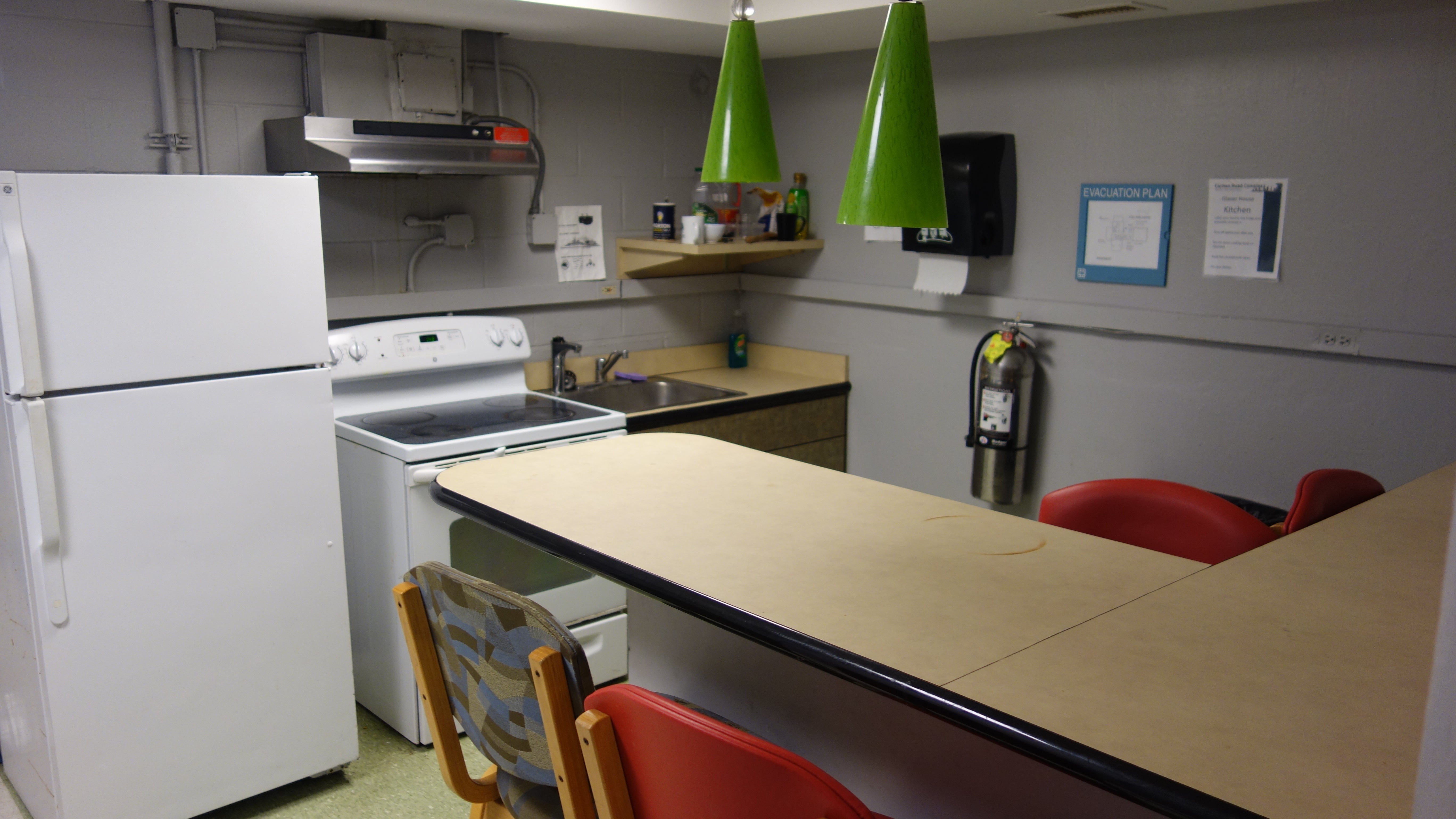 Glaser House Basement Kitchen showing counter, appliances, and bar stools
