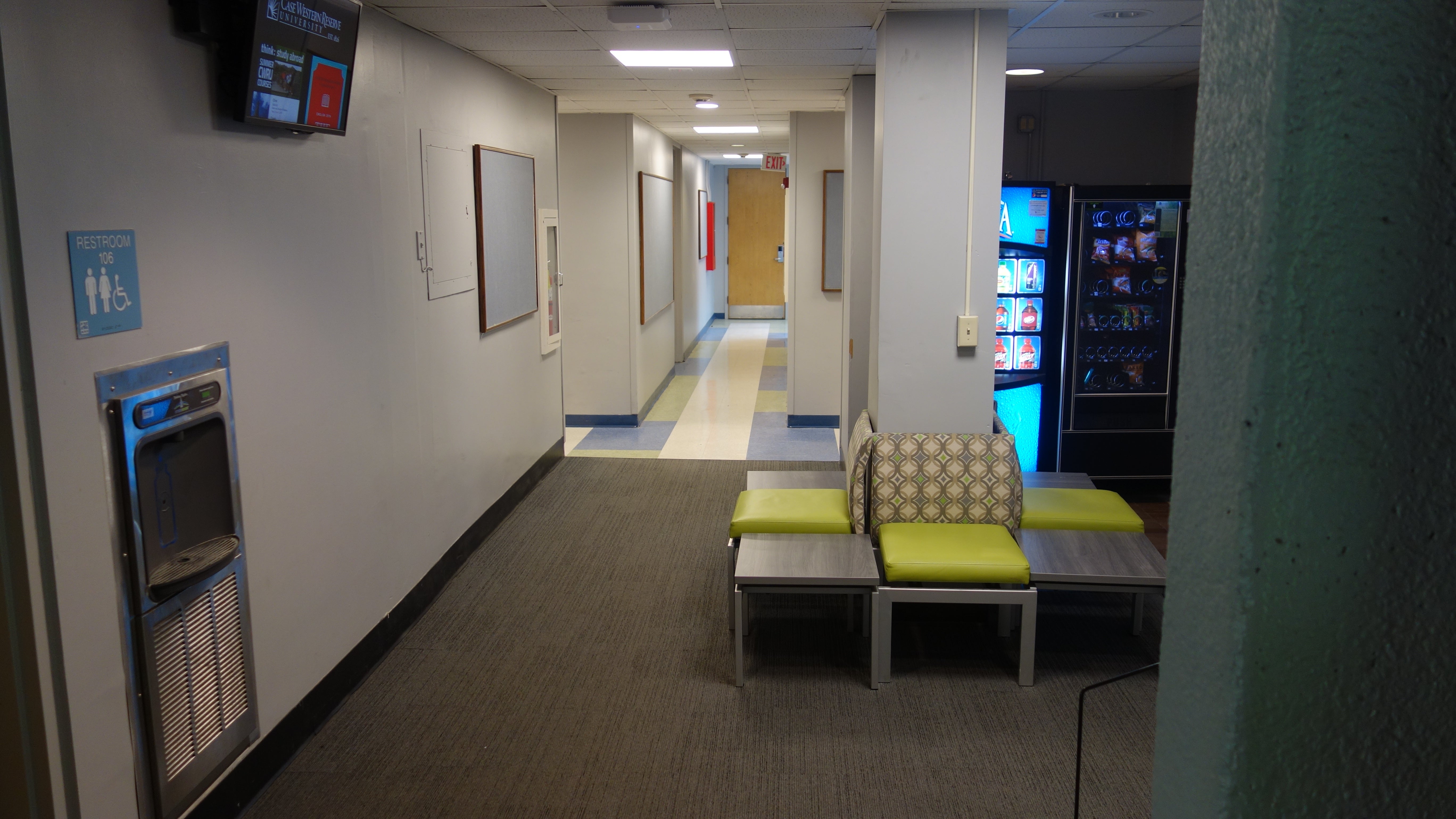 Glaser House 1st Floor Hallway showing restroom, chairs, and vending machines