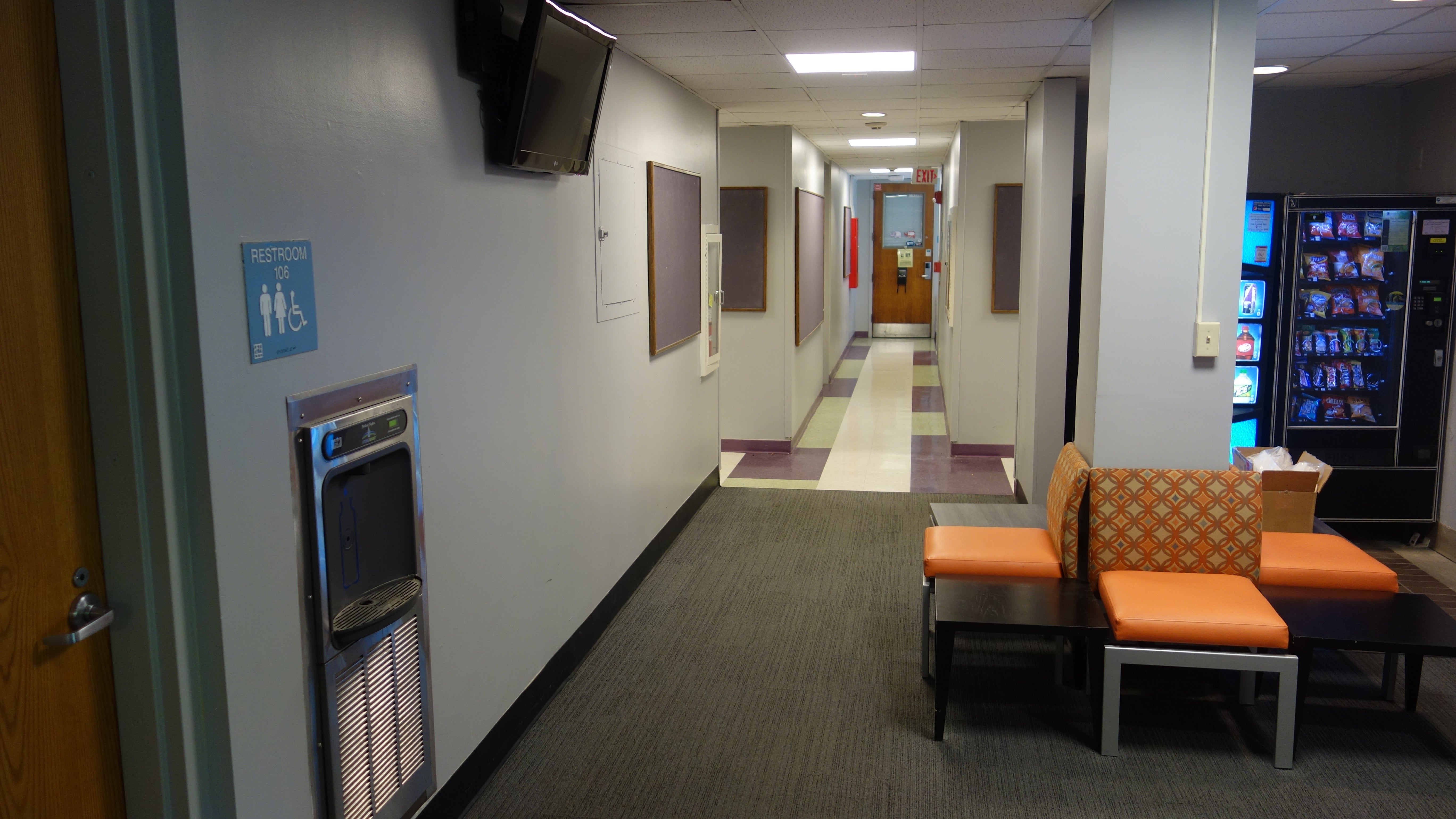 Michelson House 1st Floor Hallway showing restroom, vending machines, chairs