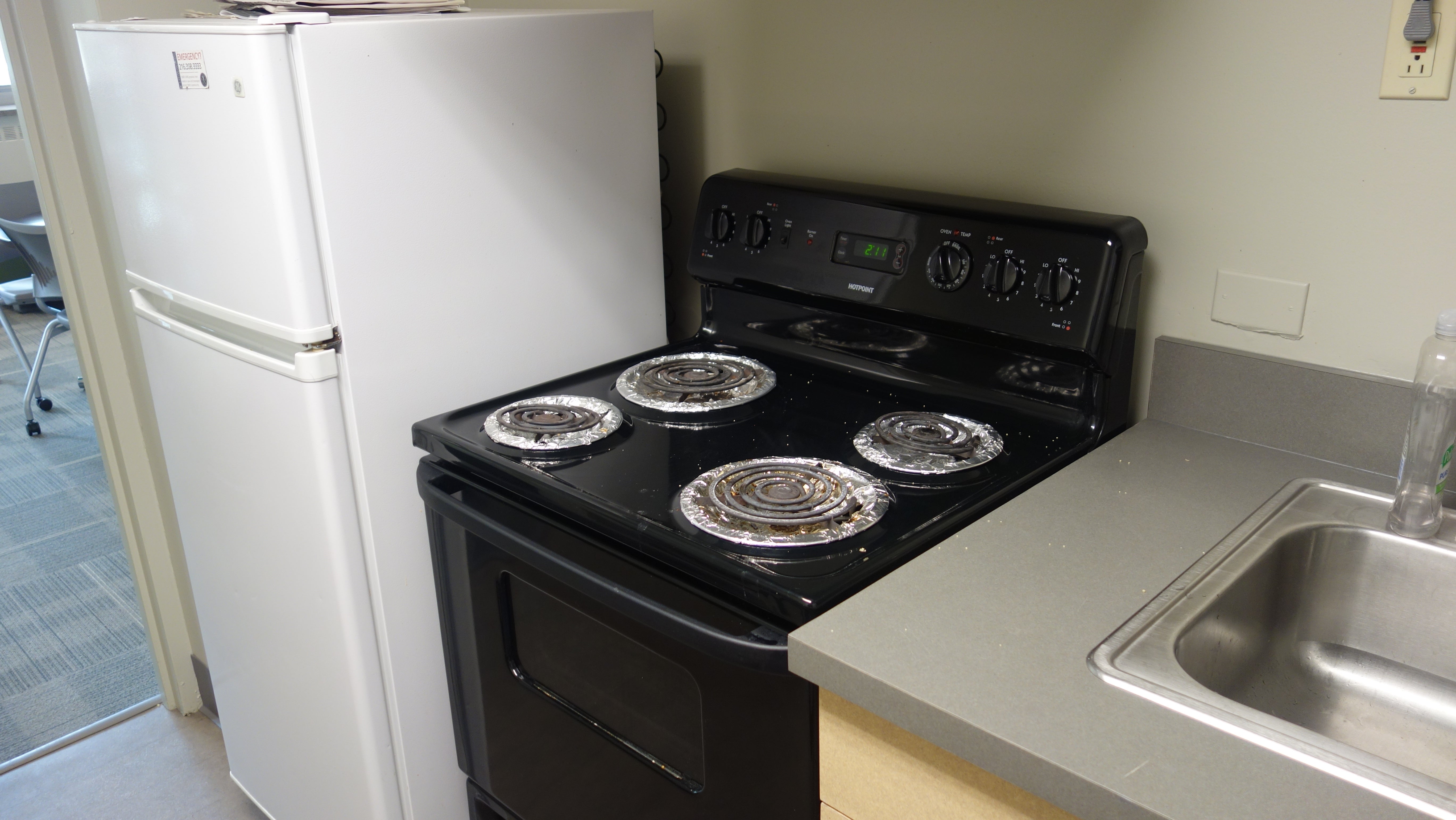 Howe House 1st Floor Kitchen showing fridge, stove, and sink