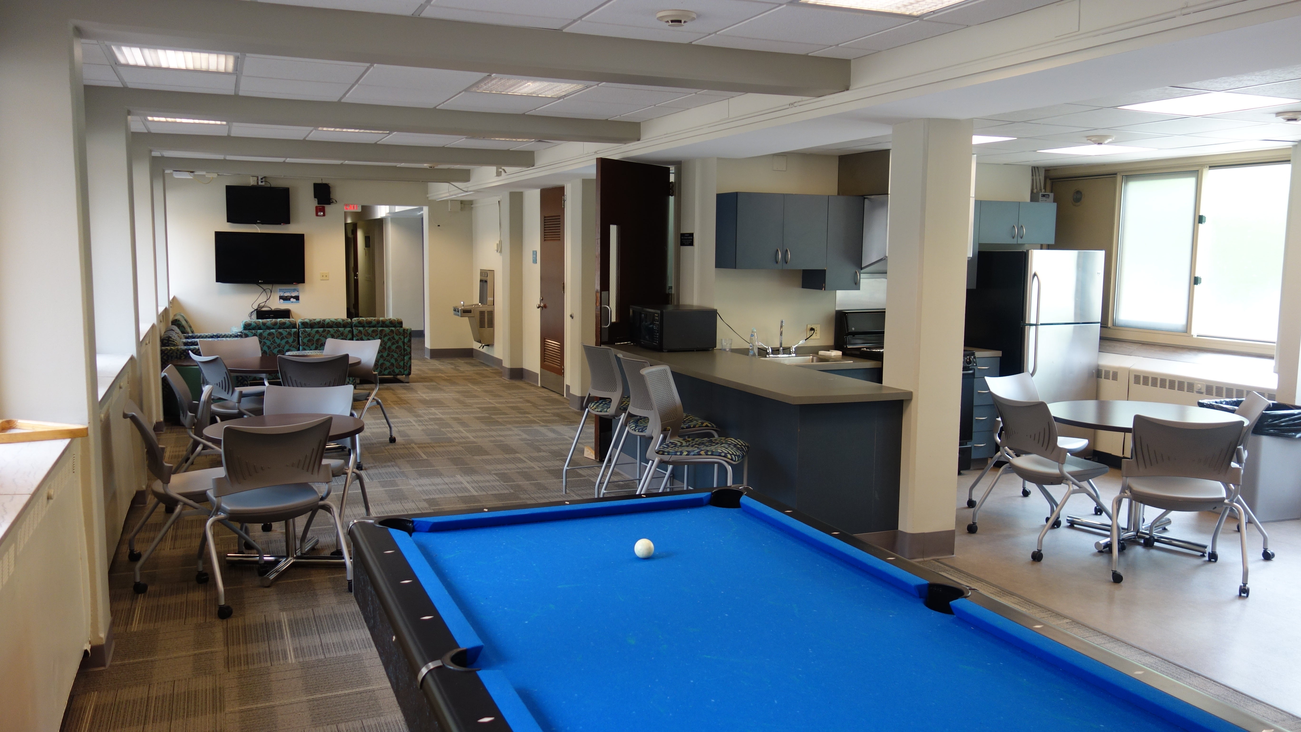 Tippit House Common Room showing pool table, kitchen, and furniture