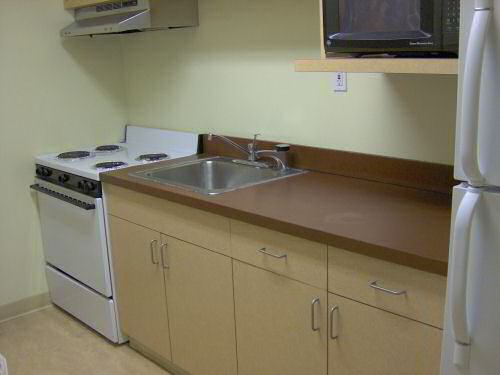 Storrs House Kitchen with stove, sink, microwave, and fridge