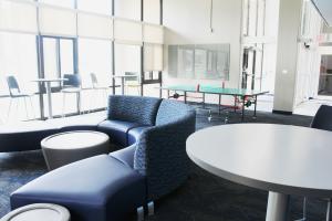 Clarke Tower Lounge with couches, coffee tables, and ping pong table