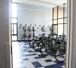 Clarke Tower 1st Floor Bike Storage with wall-mounted hooks, bike racks, and several bikes
