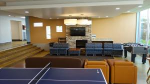 Taplin House Common Room showing furniture, television, and game tables
