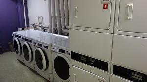 Michelson House Basement Laundry Room showing washers and stacked dryers