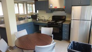 Tippit House Common Kitchen showing table, chairs, and appliances