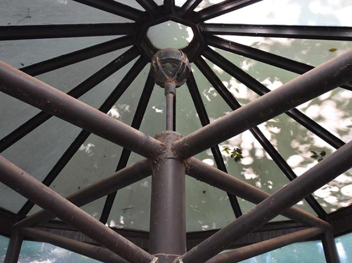A metal structure with a glass roof